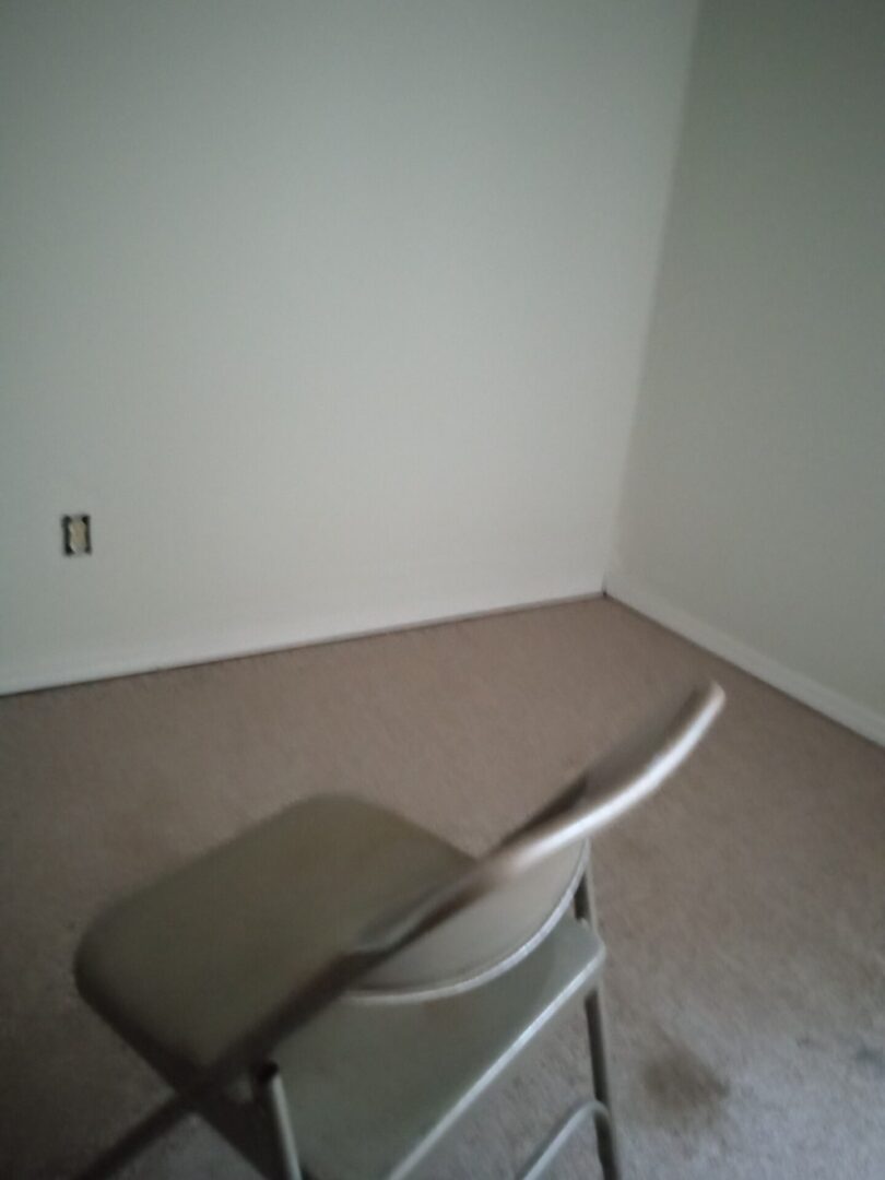 A chair in the corner of a room with no walls.