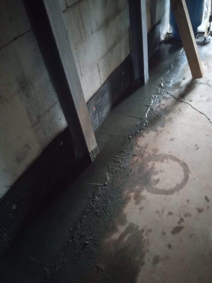 A room with water and dirt on the floor.